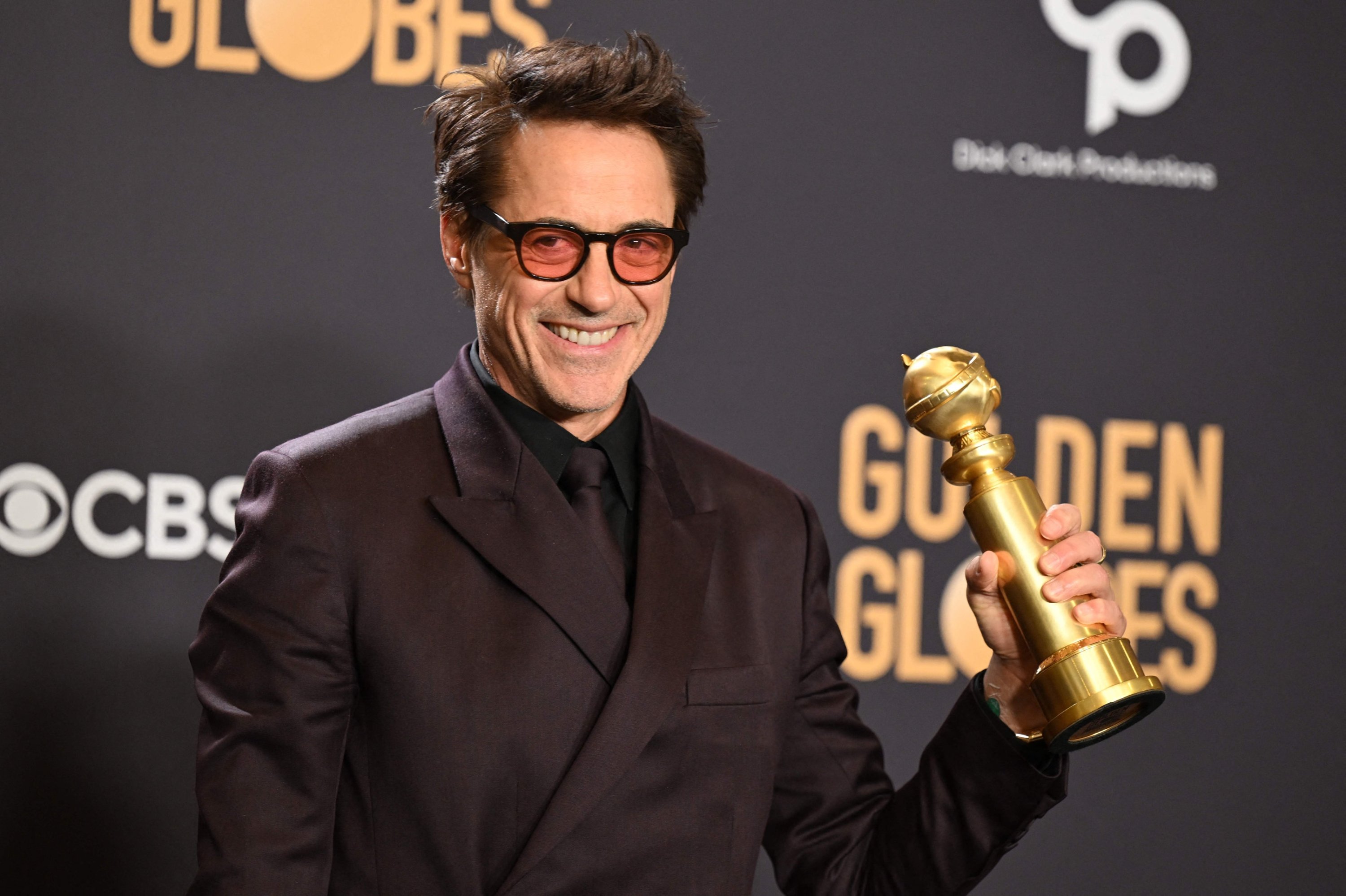 309063 U.S. actor Robert Downey Jr. poses in the press room with the award for Best Performance by a Male Actor in a Supporting Role in any Motion Picture for