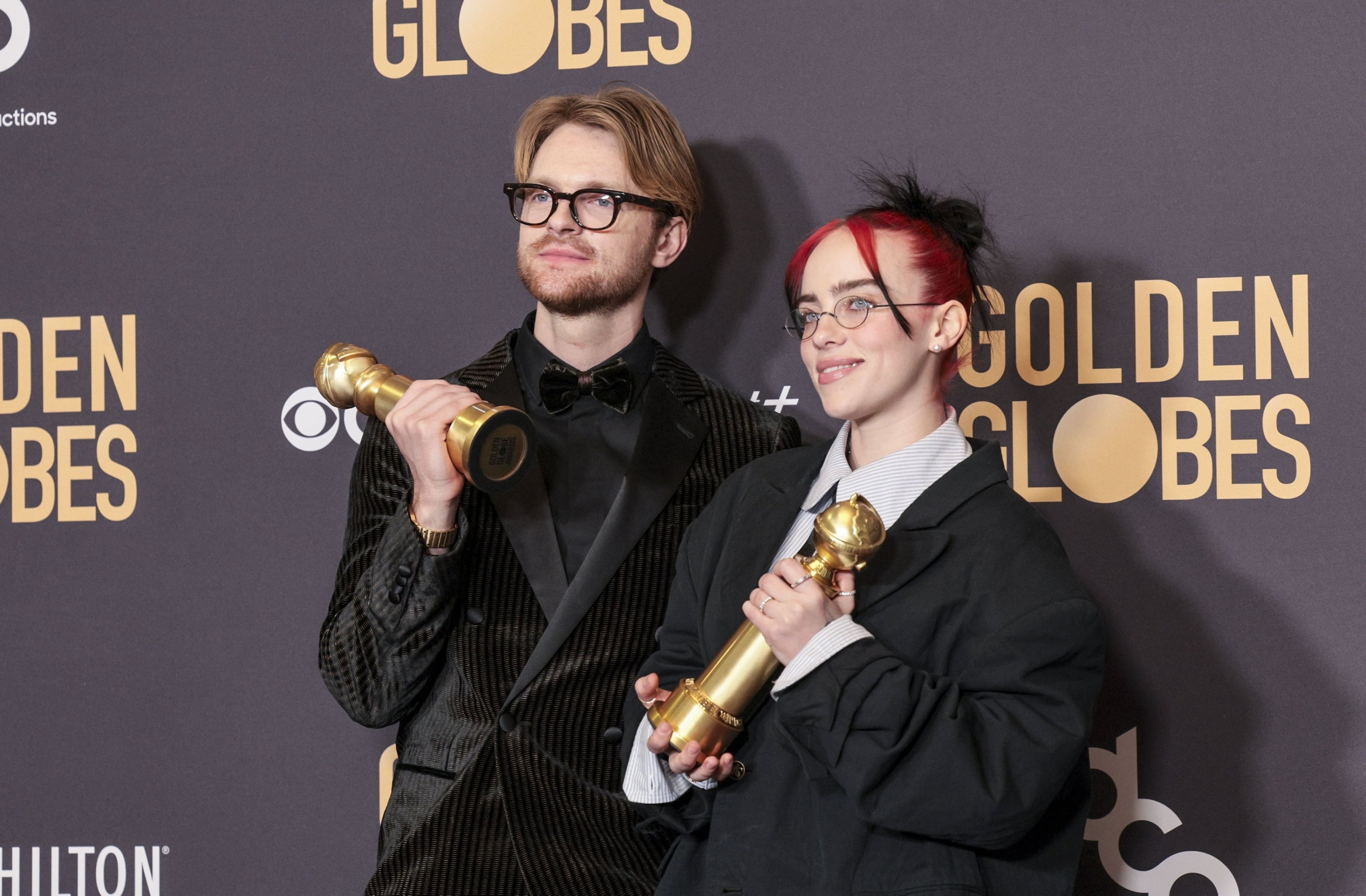 309068 U.S. musicians Finneas O'Connell (L) and Billie Eilish (R) pose with the Golden Globe for Best Original Song - Motion Picture