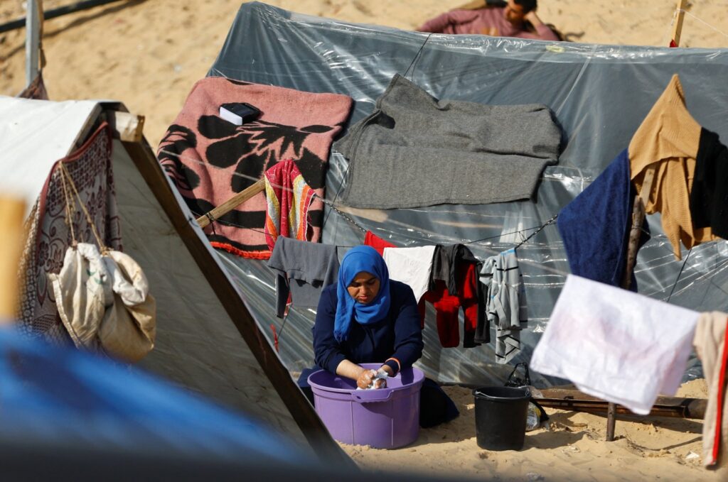 A displaced Palestinian woman, who fled her house due to Israeli strikes, shelters at a tent camp in Rafah in the southern Gaza Strip, Palestine, Jan. 8, 2024. (Reuters Photo)