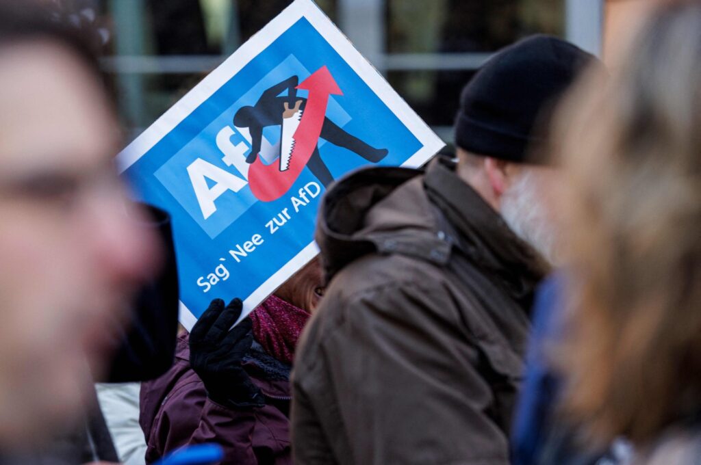 A person holds up a placard reading "Say Nope to AFD" as she takes part in a demonstration against racism and far-right politics, in Erfurt, eastern Germany on Jan. 20, 2024. (AFP Photo)