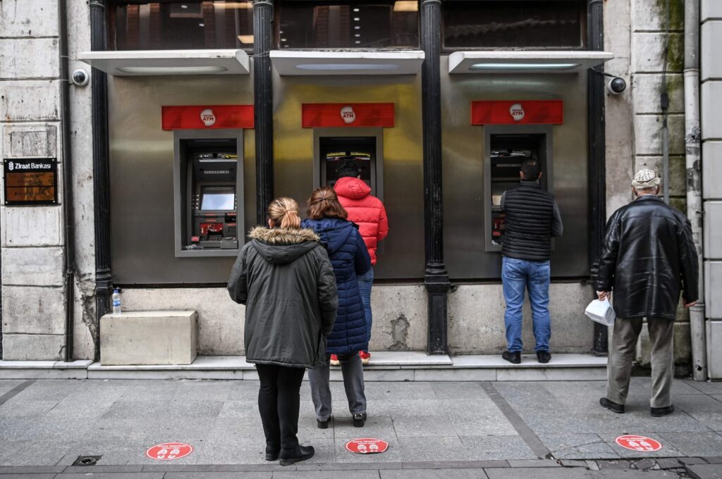 Customers wait in line to use the ATMs of a Turkish bank near Eminönü neighborhood, in Istanbul, Türkiye, March 22, 2021. (AFP Photo)