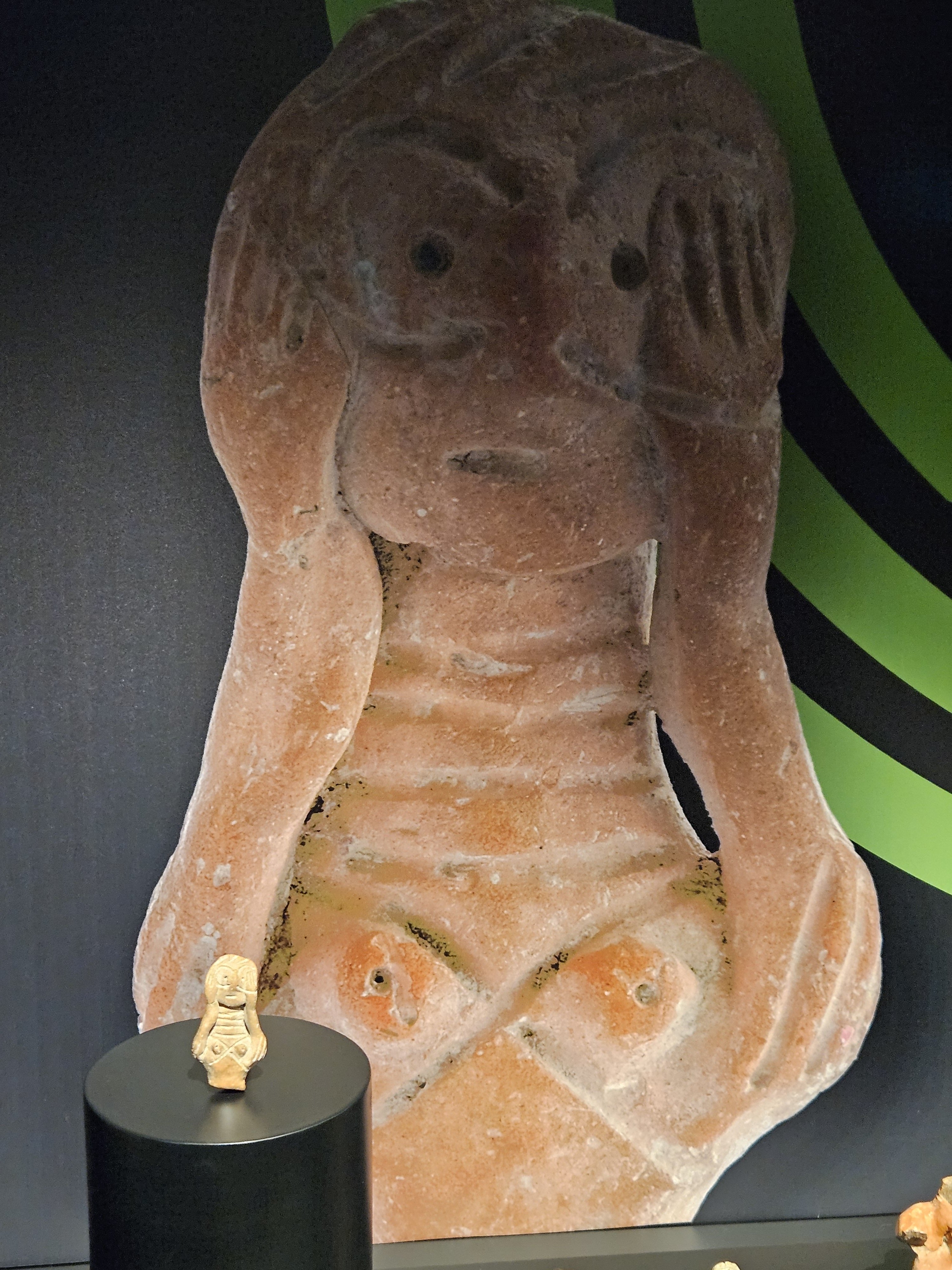 315771 Archaic figurine, early Bronze Age, pre-2000 B.C., size 5.4 x 3 x 1.3 centimeters discovered in Bolvadin, with the enlarged photograph as background, Afyonkarahisar, Türkiye. (Photo by A. Peter Dore)