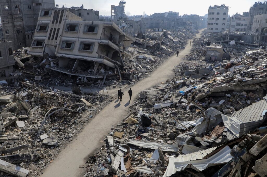Palestinians walk past houses destroyed by Israeli bombardments, in Jabalia refugee camp, in the northern Gaza Strip, Palestine, Feb. 22, 2024. (Reuters Photo)