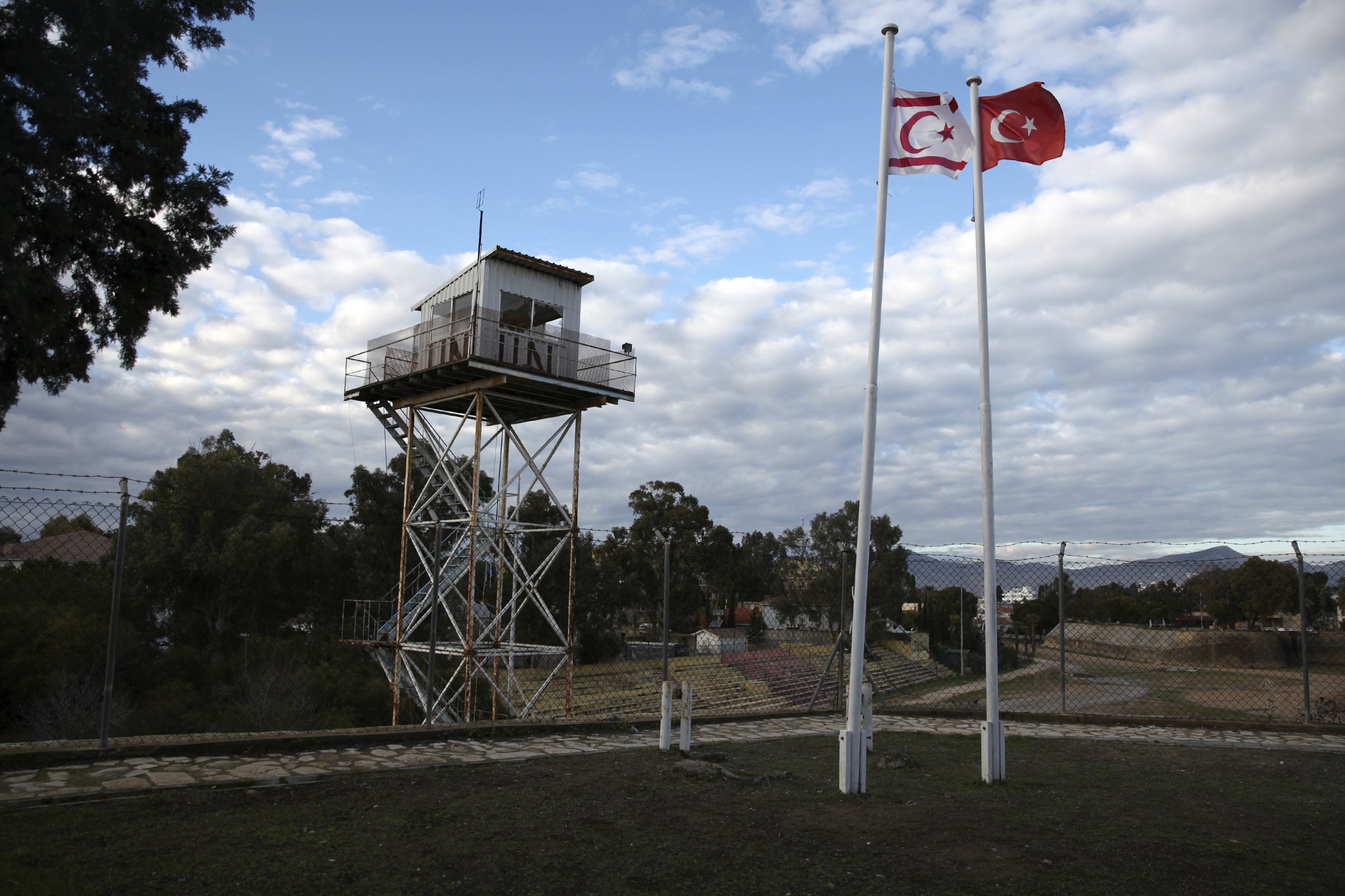 317257 A U.N. guard post is seen on the buffer zone as a Turkish and a Turkish Cypriot flag wave on the Turkish Cypriot northern part of the city of Lefkoşa (Nicosia), Cyprus, Jan. 12, 2017. (Reuters Photo)
