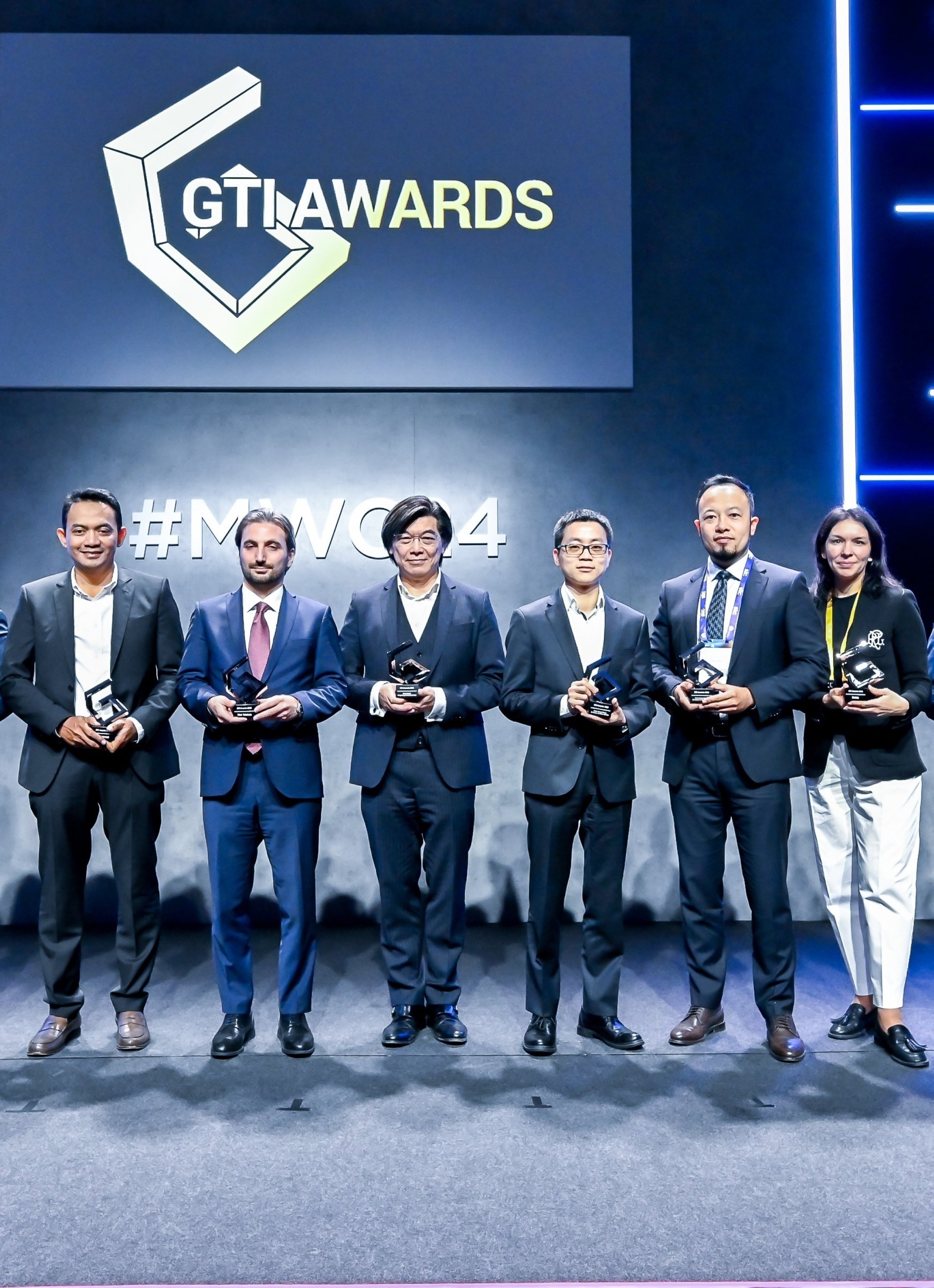 317567 Ismail Emanet (2nd L), general manager of Argela, poses for a photo with other award winners at THE GTI Awards, Barcelona, Spain, Feb. 28, 2024. (IHA Photo)
