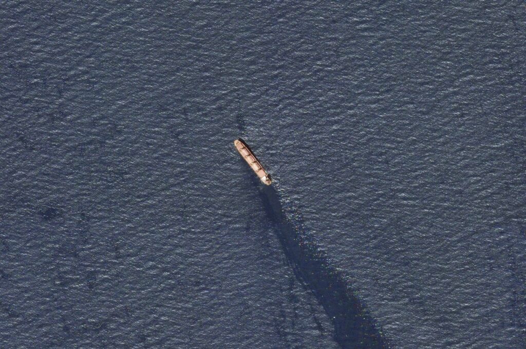 In this satellite image provided by Planet Labs, the Belize-flagged bulk carrier Rubymar is seen in the southern Red Sea near the Bay el-Mandeb Strait leaking oil after an attack by Yemen's Houthi rebels Tuesday, Feb. 20, 2024. (AP Photo)