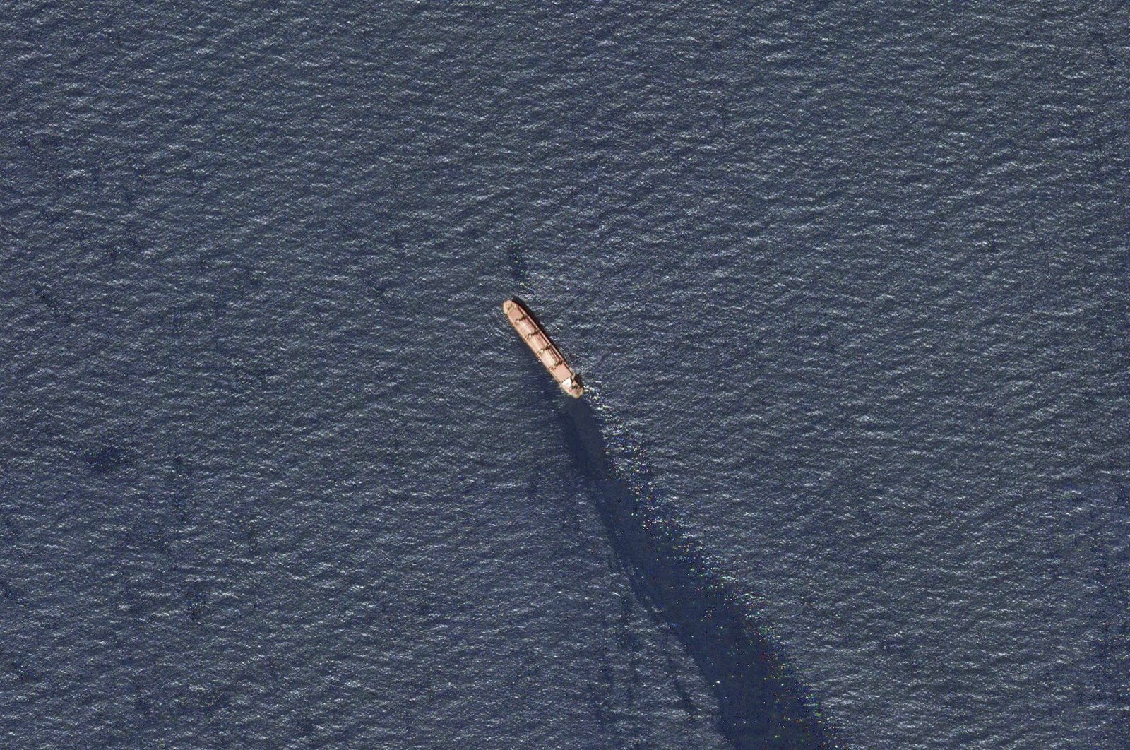 In this satellite image provided by Planet Labs, the Belize-flagged bulk carrier Rubymar is seen in the southern Red Sea near the Bay el-Mandeb Strait leaking oil after an attack by Yemen's Houthi rebels Tuesday, Feb. 20, 2024. (AP Photo)