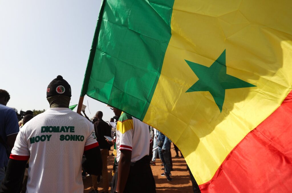 A demonstrator raises Senegal's national flag during a march in Dakar, Senegal, March 2, 2024. (AFP Photo)
