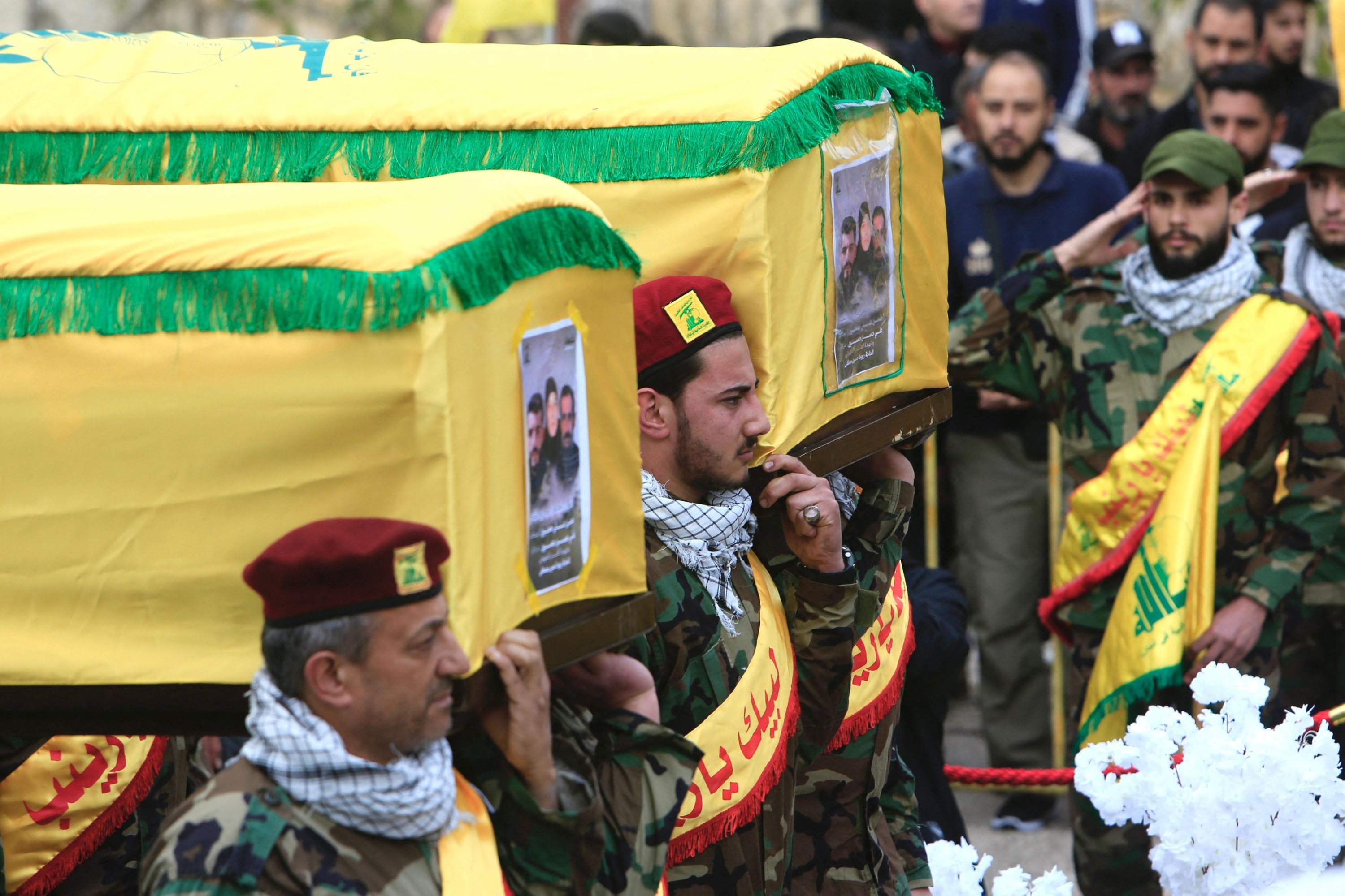 318753 Hezbollah members and supporters attend the funeral of one of the group's members Hassan Hussein, his wife Ruwaida Mustafa, and their 25-year-old son Ali Hussein, killed in Israeli bombardment, during their funeral in their southern Lebanese village of Houla, March 6, 2024. (AFP Photo)