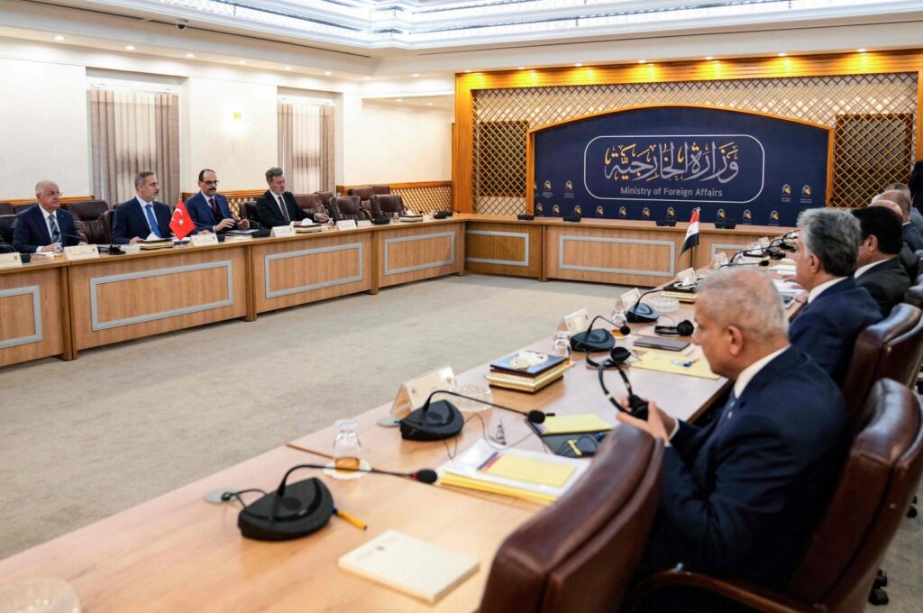 Iraq's foreign minister Fuad Hussein and other officials (R) meet with a visiting Turkish delegation headed by Foreign Minister Hakan Fidan (2nd L) in Baghdad, Iraq, March 14, 2024. (AFP Photo)