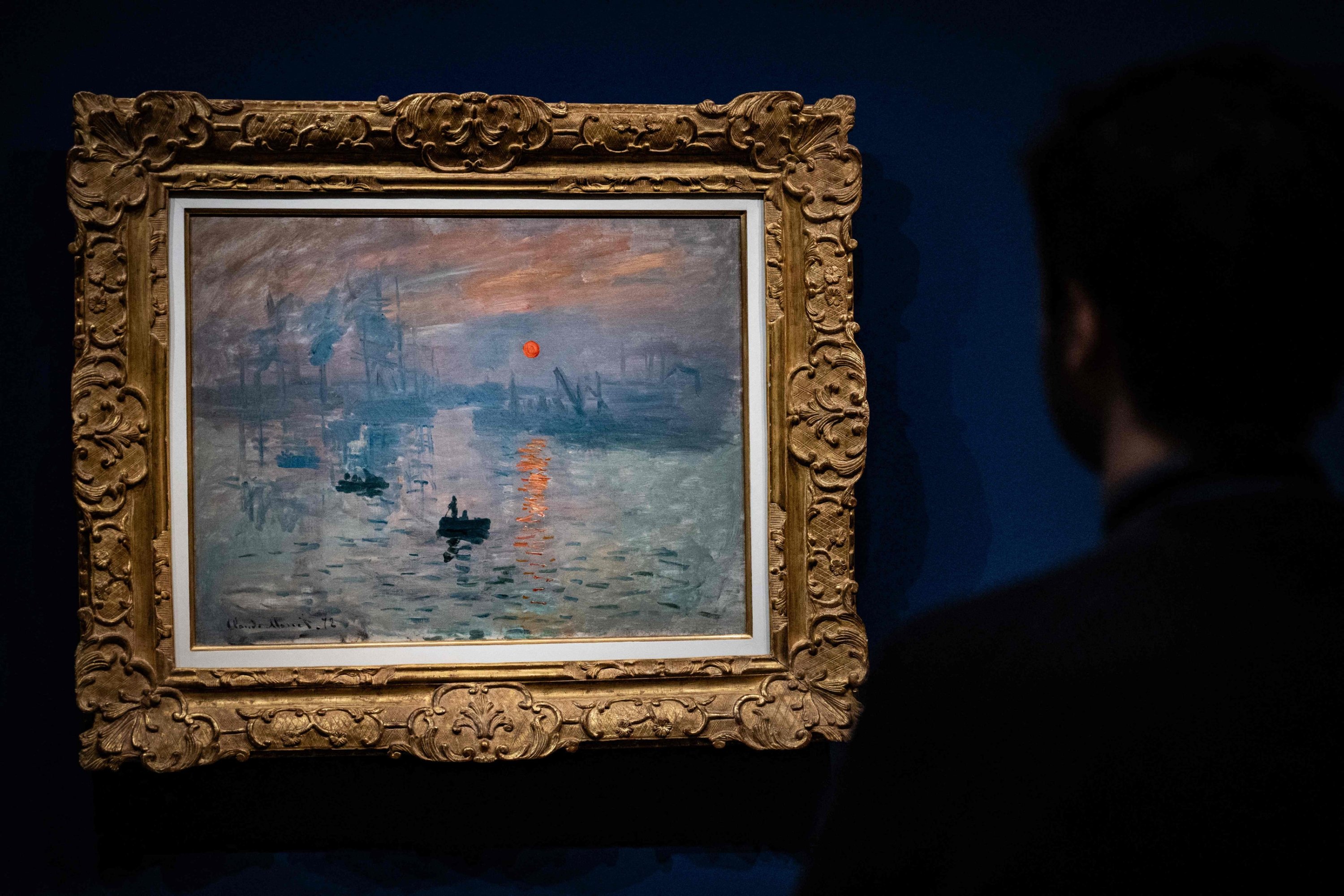 320838 A man stands in front of the painting