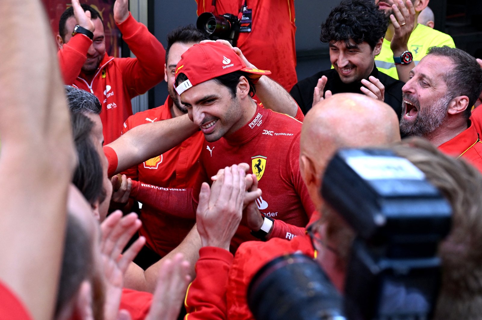 Ferrari's Carlos Sainz Jr. (C) celebrates winning the F1 Australian Grand Prix, Melbourne, Australia, March 24, 2024. (Reuters Photo)