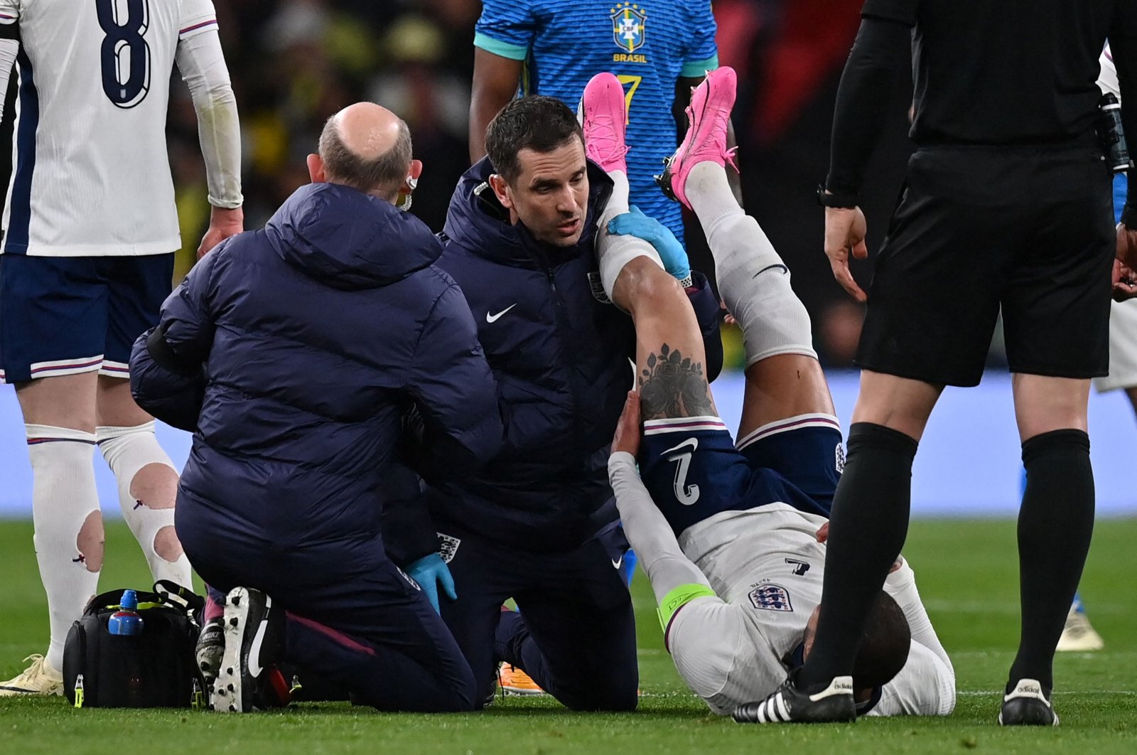 England's defender Kyle Walker (R) is treated by medical staff after picking up an injury during the international friendly football match between England and Brazil at Wembley Stadium, London, U.K., March 23, 2024. (AFP Photo)