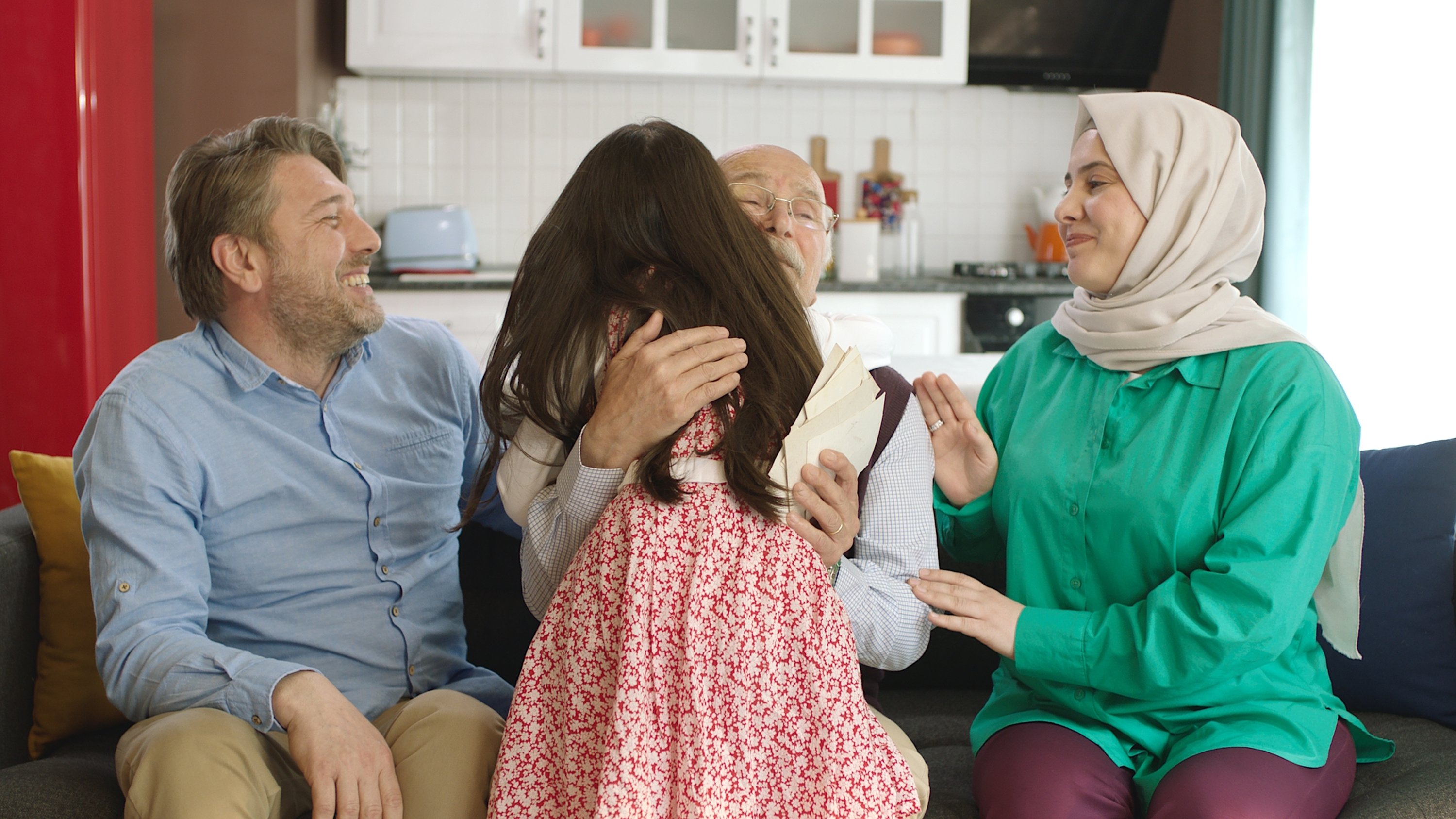 321791 Family celebrate Eid al-Fitr together, with grandparents hugging their granddaughter. (Shutterstock Photo)