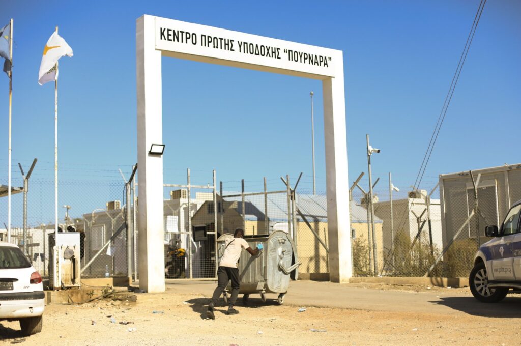 A migrant pushes an empty dumpster into the Pournara migrant reception center, near the village of Kokkinotrimitia, Lefkoşa (Nicosia), Greek Cyprus, Oct. 29, 2022. (Reuters File Photo)