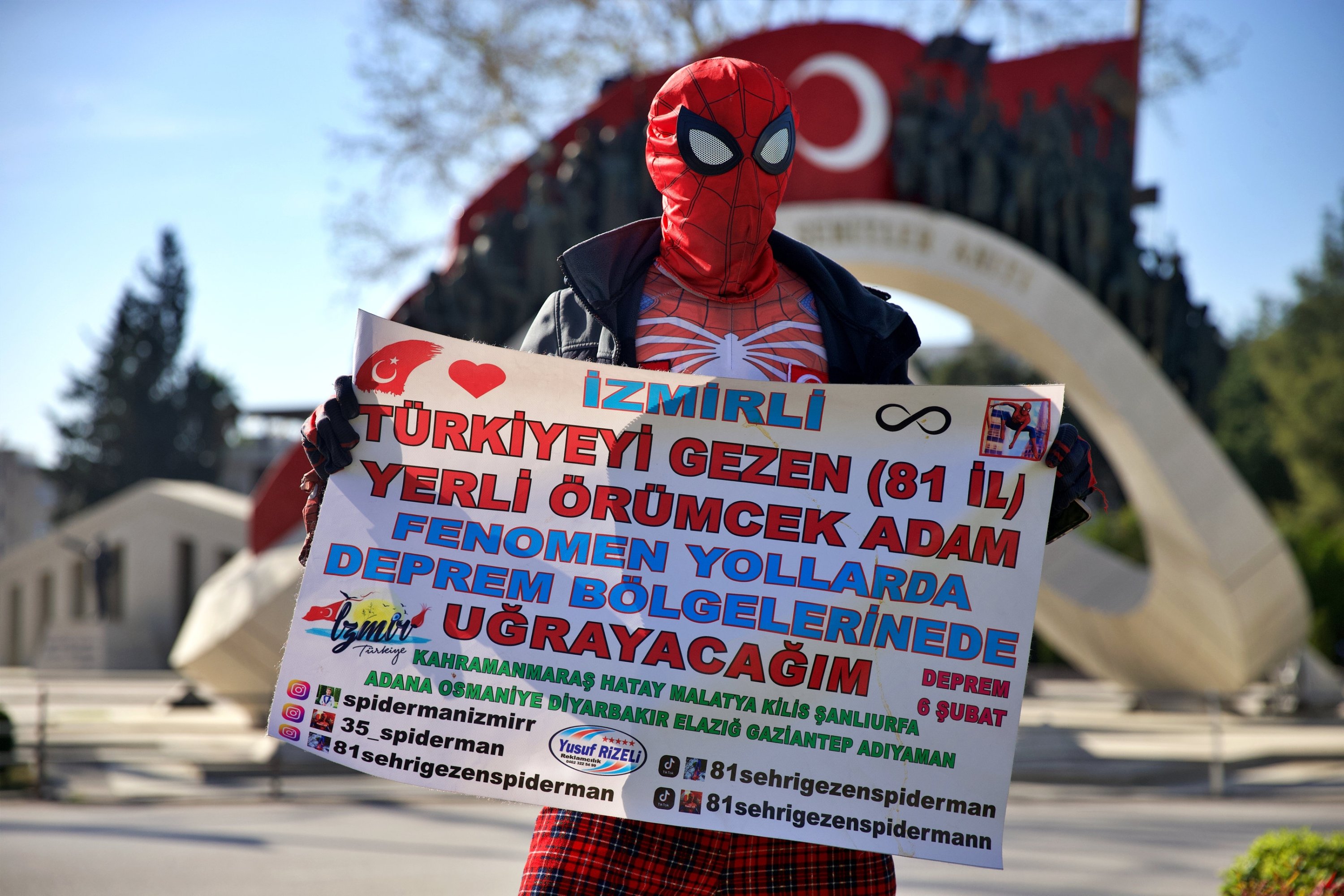 323269 Ayaz Koç, dressed as Spider-Man, holds a sign reading: 'Famous local Spider-Man from Izmir, traveling to 81 cities, ready visit the towns affected by the earthquakes,' set out from his hometown of Izmir to support families affected by last year's massive earthquakes, Izmir, Türkiye, March 30, 2024. (AA Photo)