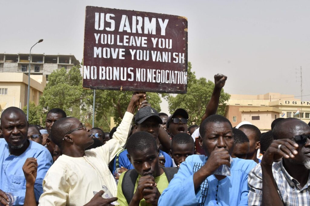 A man holds up a sign demanding that American soldiers leave Niger without negotiation during a demonstration, Niamey, Niger, April 13, 2024. (AFP Photo)