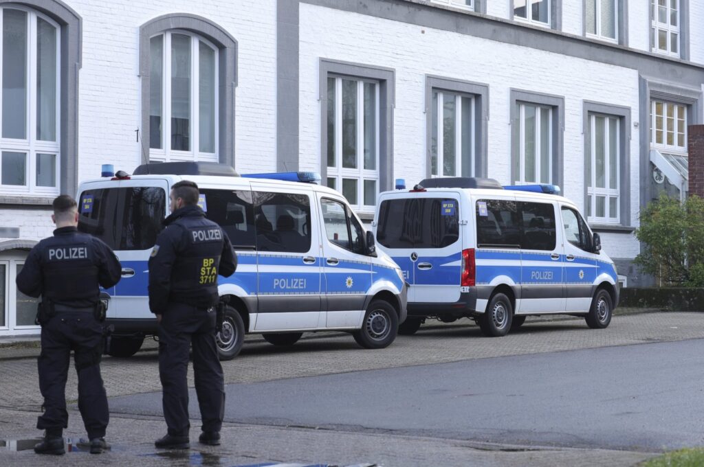 Police officers stand near a building that is being searched in Solingen, Germany, Wednesday April 17, 2024. (DPA PHoto)