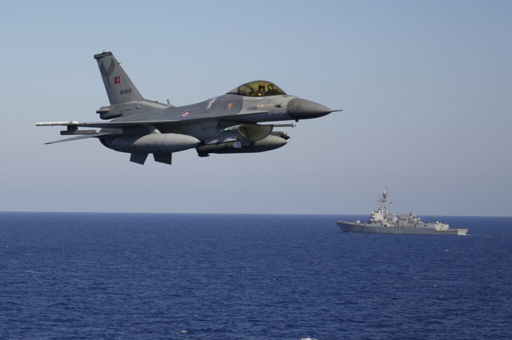 A Turkish F-16 fighting jet flies over naval ships during an annual NATO naval exercise on Türkiye's western coast on the Mediterranean, Sept. 15, 2022.  (AP Photo)