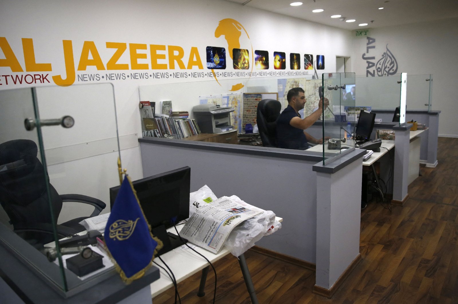An employee of the Qatar-based news network and TV channel Al-Jazeera is seen at the channel's Jerusalem office, July 31, 2017. (AFP File Photo)