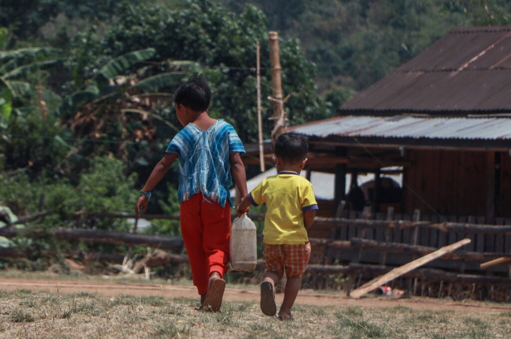 Children carrying a water container between them at a camp for internally displaced people in Demoso township, eastern Kayah state, Myanmar, April 29, 2024. (AFP Photo)