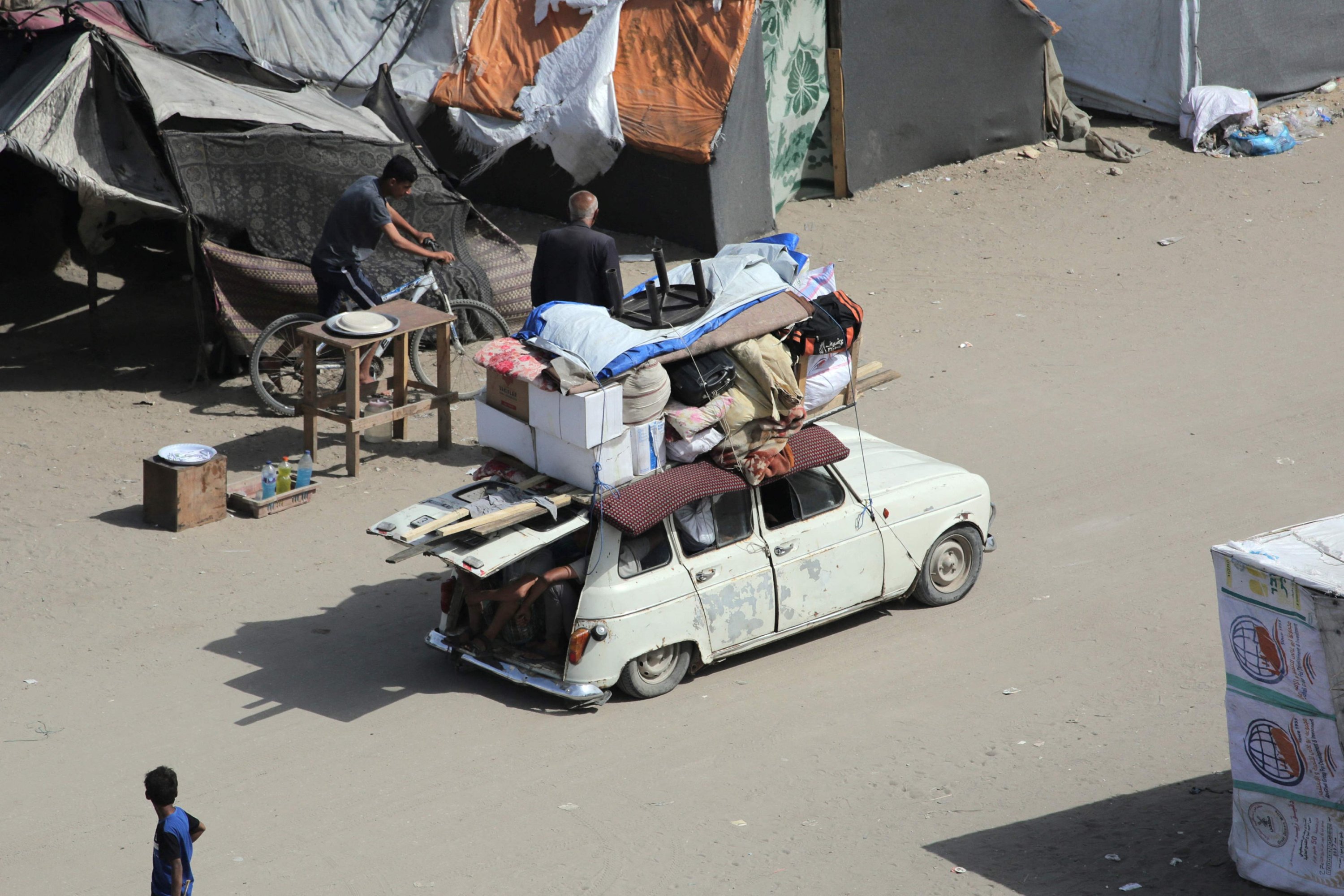 327450 Palestinians pile their belongings on a vehicle as it drives amidst tents housing internally displaced people, in Deir el-Balah, central Gaza Strip, Palestine, May 10, 2024. (AFP Photo)