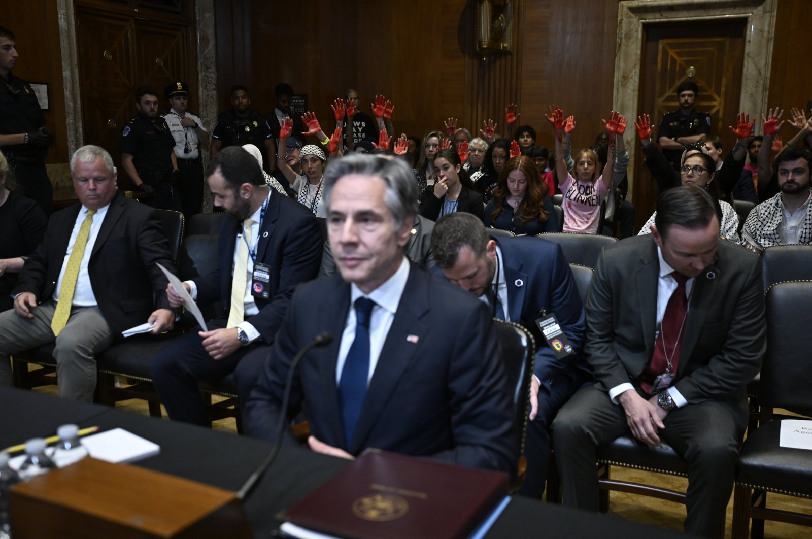 Pro-Palestinian demonstrators show their red-painted hands as they interrupt U.S. Secretary of State Antony Blinken's testimony before the U.S. Senate Foreign Relations Committee at the Capitol, in Washington, D.C., May 21, 2024. (AA Photo)