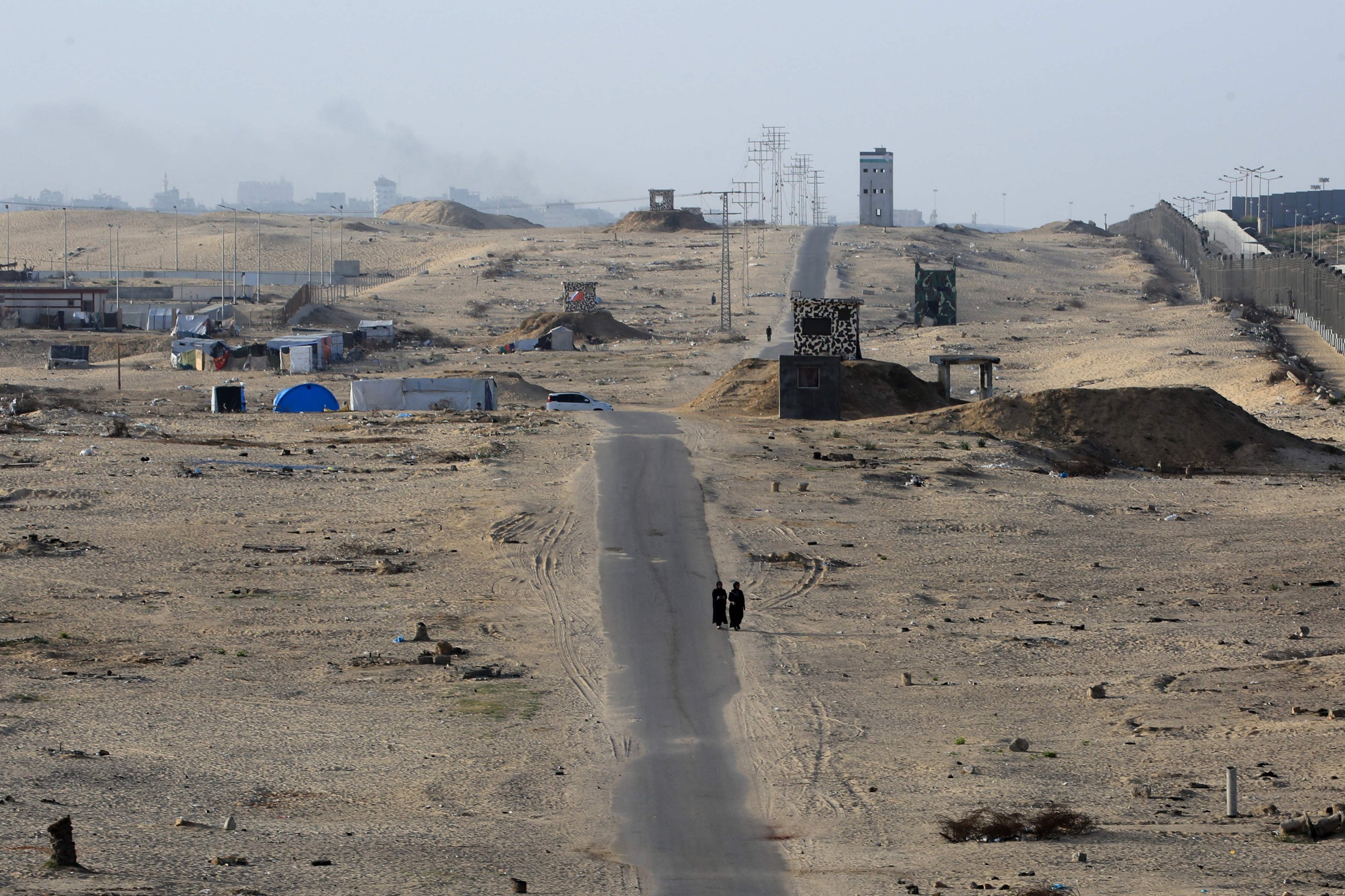 329575 Two women walk on an asphalted road in the middle of a deserted camp for displaced Palestinians on the border with Egypt in Rafah, southern Gaza Strip, Palestine, May 22, 2024. (AFP Photo)