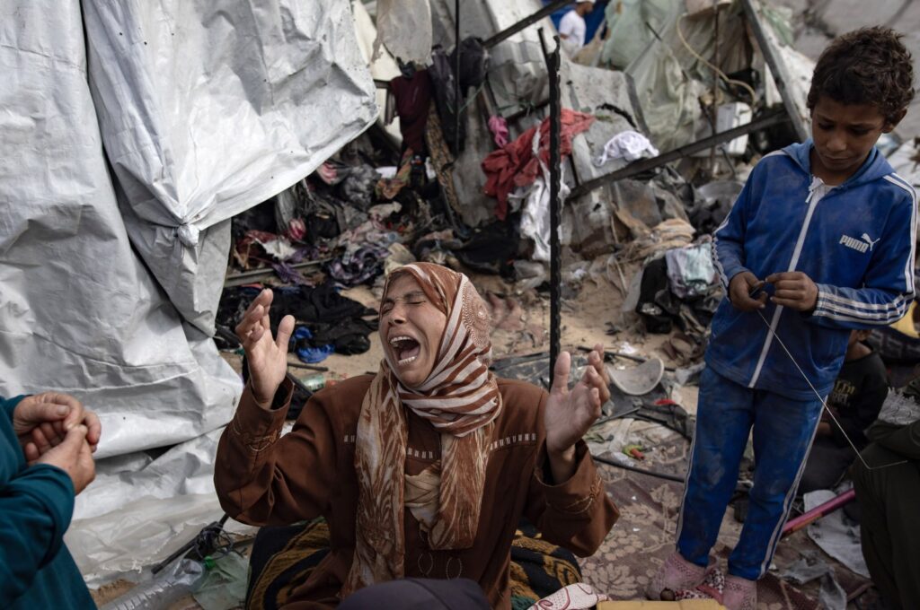 A woman reacts as Palestinians inspect the aftermath of Israel's airstrike on a tent camp in an area previously designated by the Israeli army as safe for displaced Palestinians, Rafah, southern Gaza Strip, Palestine, May 28, 2024. (EPA Photo)