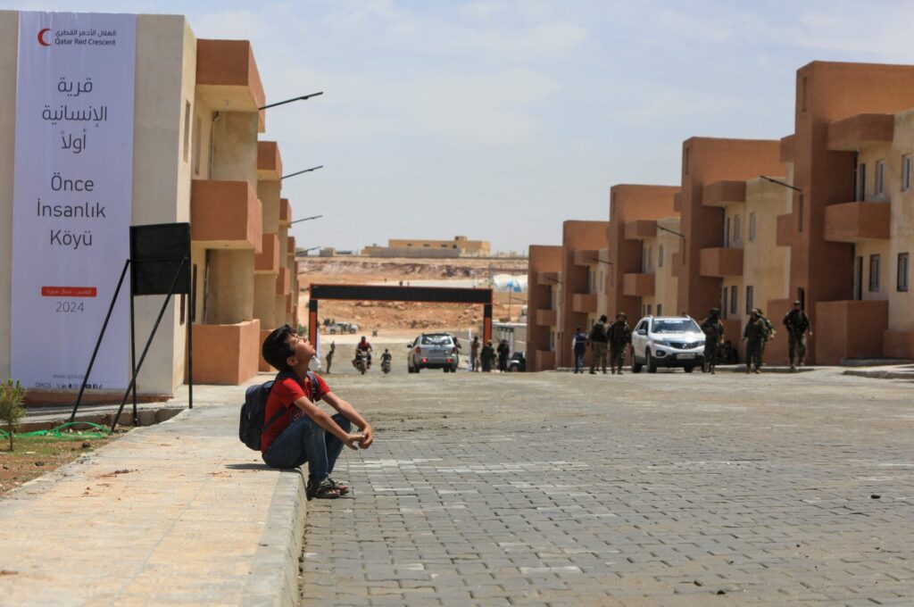 A child looks on at a block of newly constructed homes for displaced people near the town of Qabasin, northeast of al-Bab, some 30 kilometers from Aleppo, Syria, May 28, 2024. (AFP Photo)