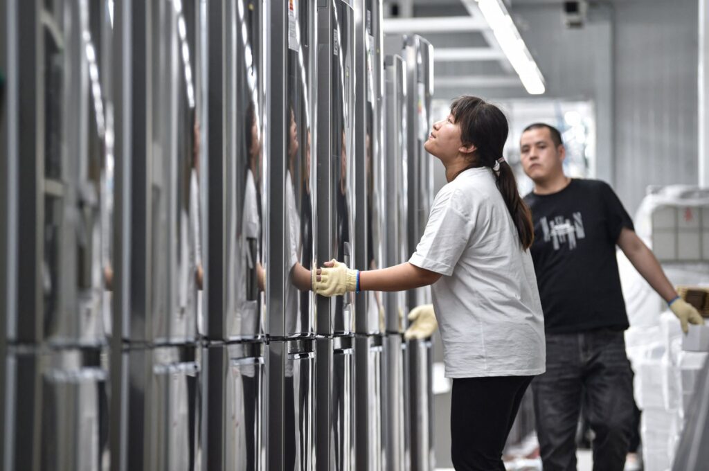 Employees work on a refrigerator assembly line at a factory for LG Electronics in Taizhou, in eastern Jiangsu province, China, May 23, 2024. (AFP Photo)