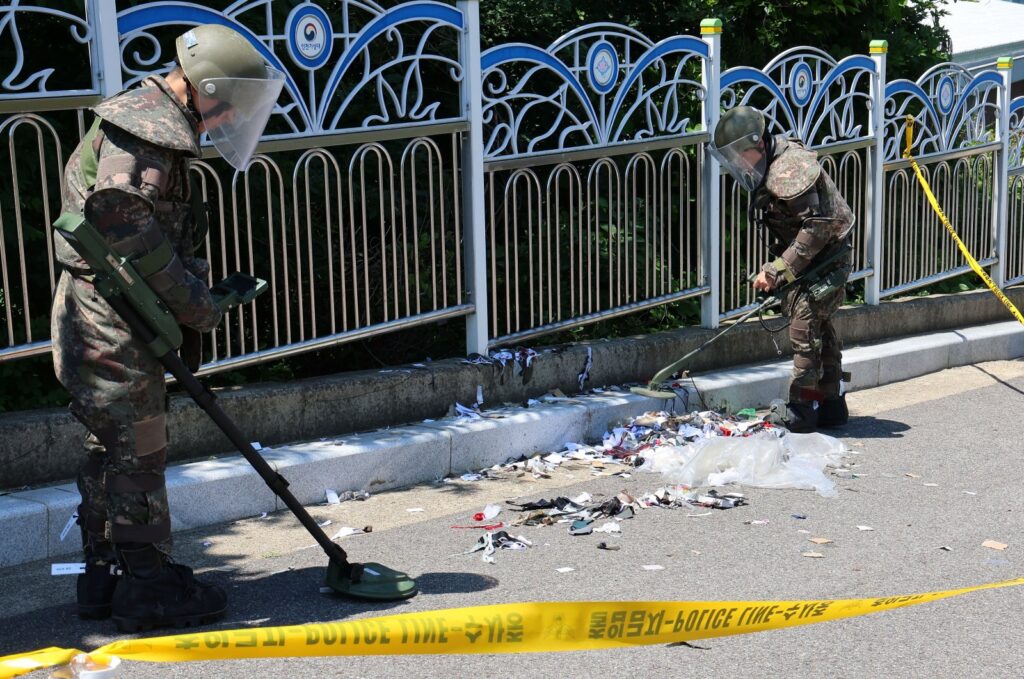 South Korean soldiers examine various objects from a balloon believed to have been sent by North Korea, in Incheon, South Korea, June 2, 2024. )
