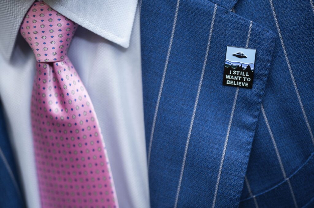 An audience member wears a UFO pin during a House Oversight and Accountability subcommittee hearing on UFOs, on Capitol Hill in Washington, D.C., July 26, 2023. (AP Photo)
