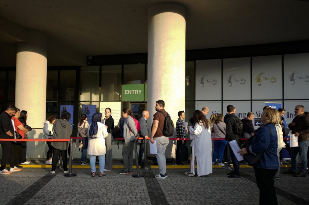 People wait for their turn at a visa application center in Istanbul, Türkiye, Nov. 3, 2023. (AP Photo)
