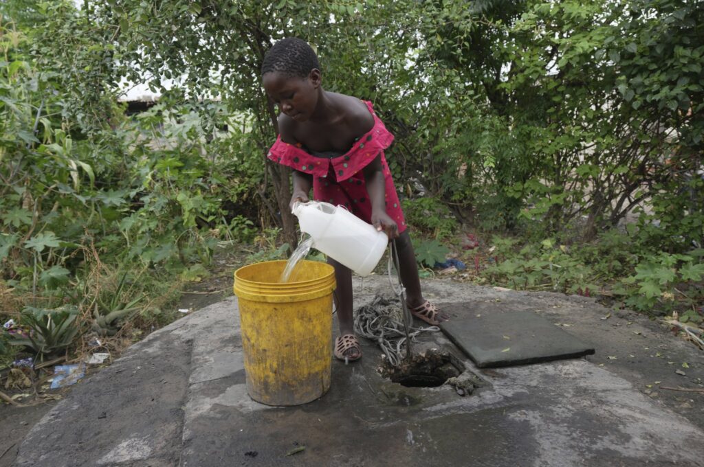 A young girl fetches water from a well in Lilanda township, Lusaka, Zambia, March 9, 2024. (AP Photo)