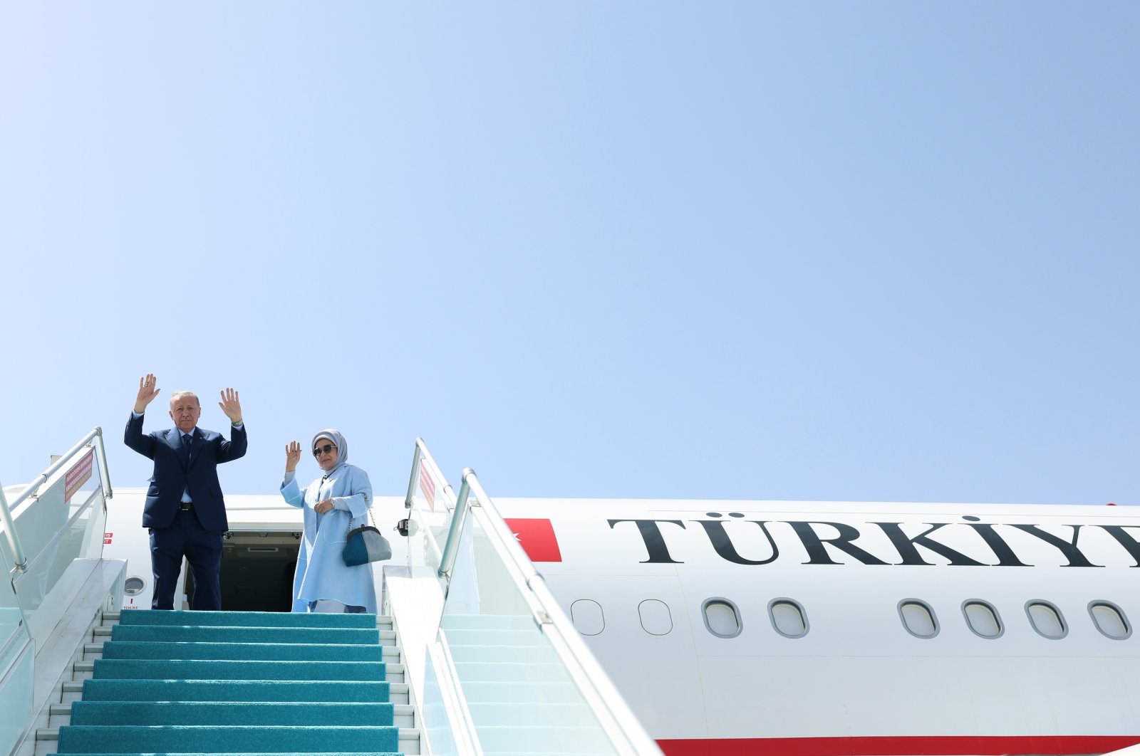 President Recep Tayyip Erdoğan (L) and first lady Emine Erdoğan wave as they embark on the presidential plane, Ankara, Türkiye, June 12, 2024. (DHA Photo)