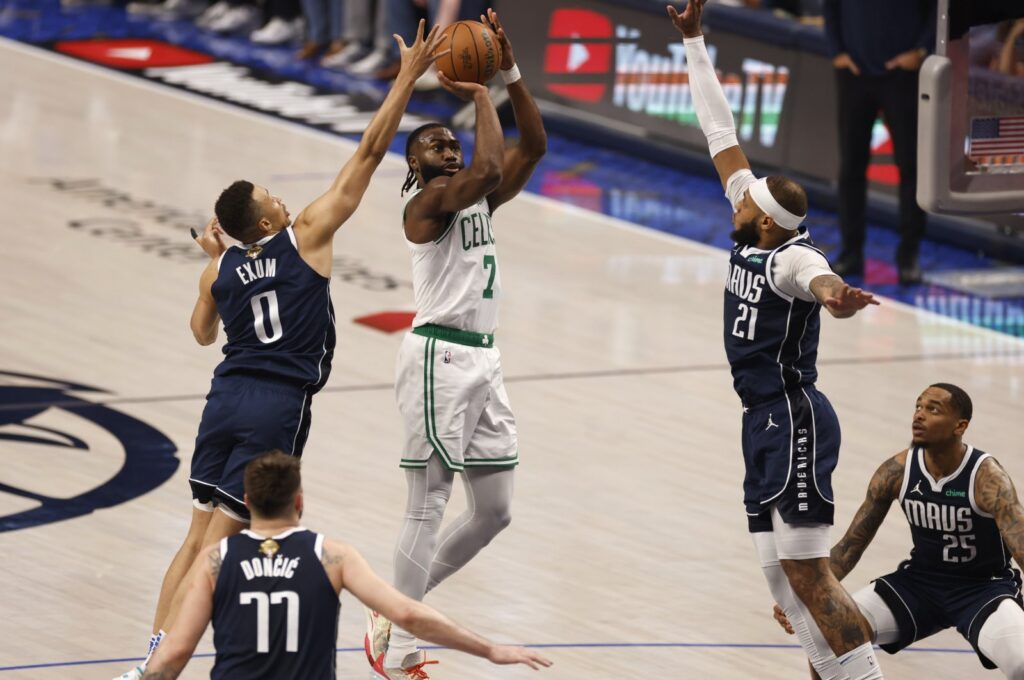 Boston Celtics guard Jaylen Brown shoots between Dallas Mavericks guard Dante Exum (L) and center Daniel Gafford defend during the first half of the NBA Finals game three, Arlington, Texas, U.S., June 12, 2024. (EPA Photo)