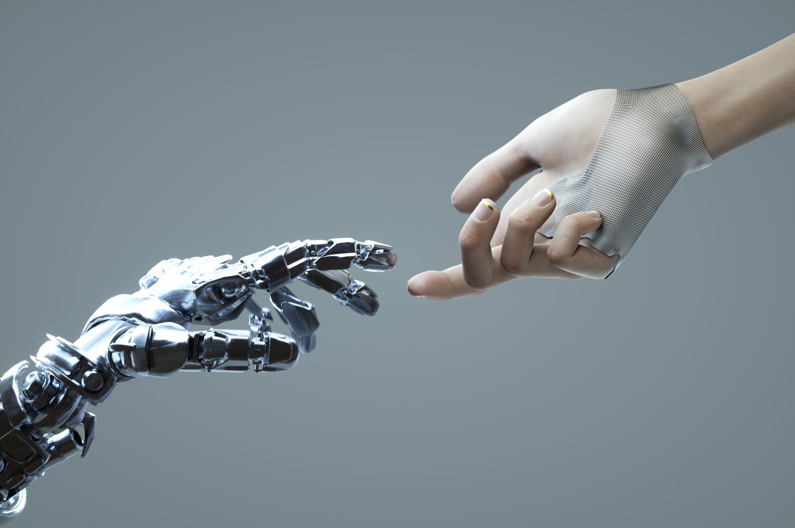 Digital generated image of female hand touching robotic hand against grey background. (Getty Images Illustration)