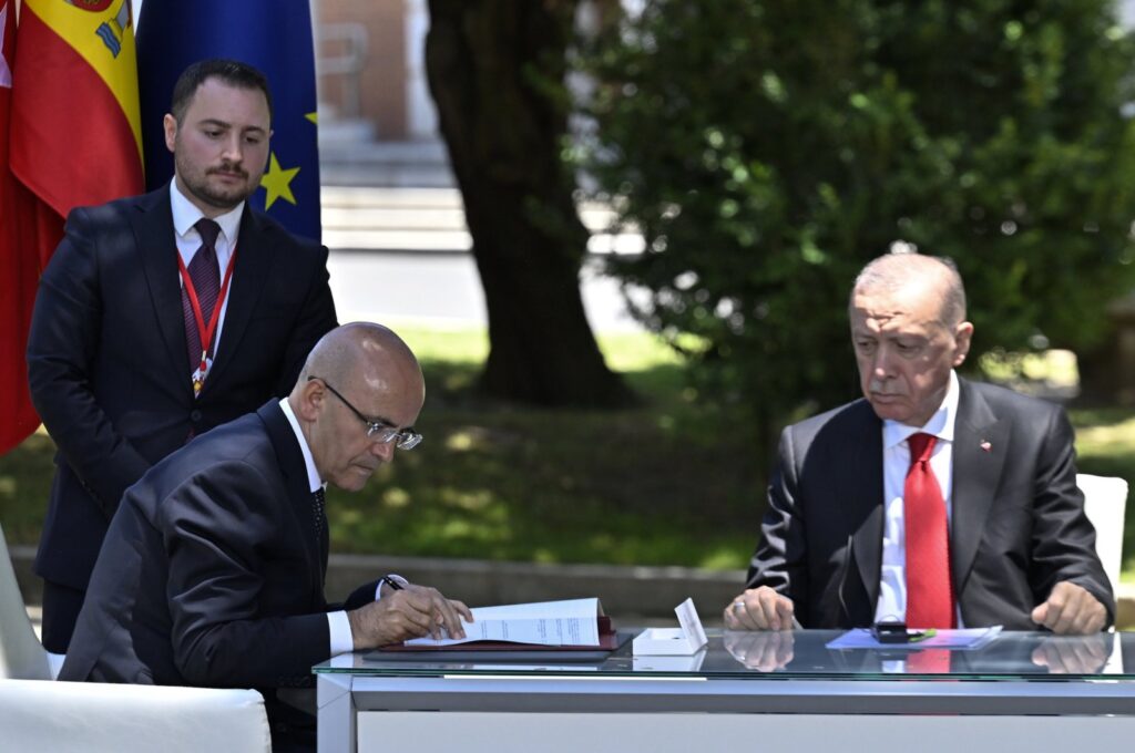 President Recep Tayyip Erdoğan watches as Treasury and Finance Minister Mehmet Şimşek signs one of Türkiye's agreements with Spain, Madrid, Spain, June 13, 2024. (AA Photo)