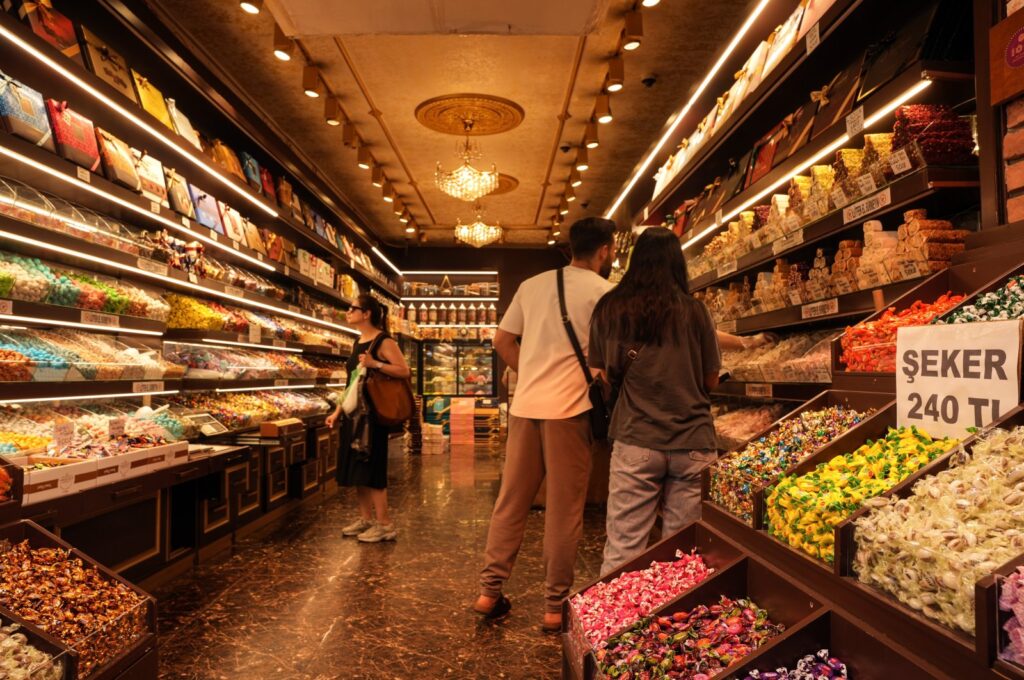 Customers shop for candies at a store in the famous Eminönü neighborhood in Istanbul, Türkiye, June 13, 2024. (IHA Photo)