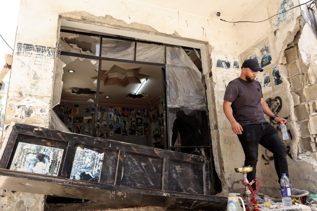 A Palestinian barber inspects his damaged shop following an Israeli operation at the Jenin refugee camp, West Bank city, Jenin, June 14, 2024. (EPA Photo)