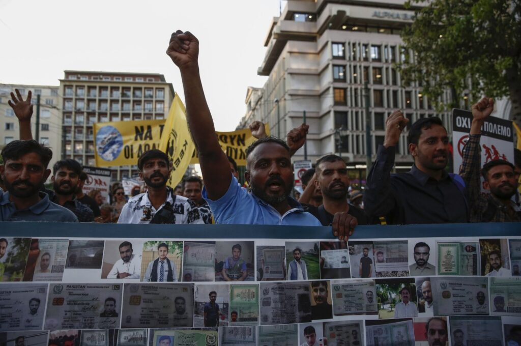 Protesters and survivors shout slogans as they hold a banner with pictures of missing and dead migrants during a rally in remembrance of the Pylos shipwreck one year ago, central Athens, Greece, June 14, 2024. (EPA Photo)