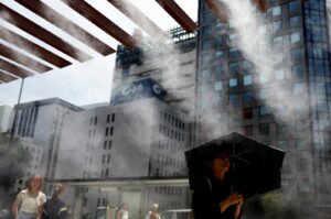 Passersby take a break under a cooling mist as the Japanese government issued a heatstroke alert in Tokyo and other prefectures, Tokyo, Japan, July 9, 2024. (Reuters Photo)