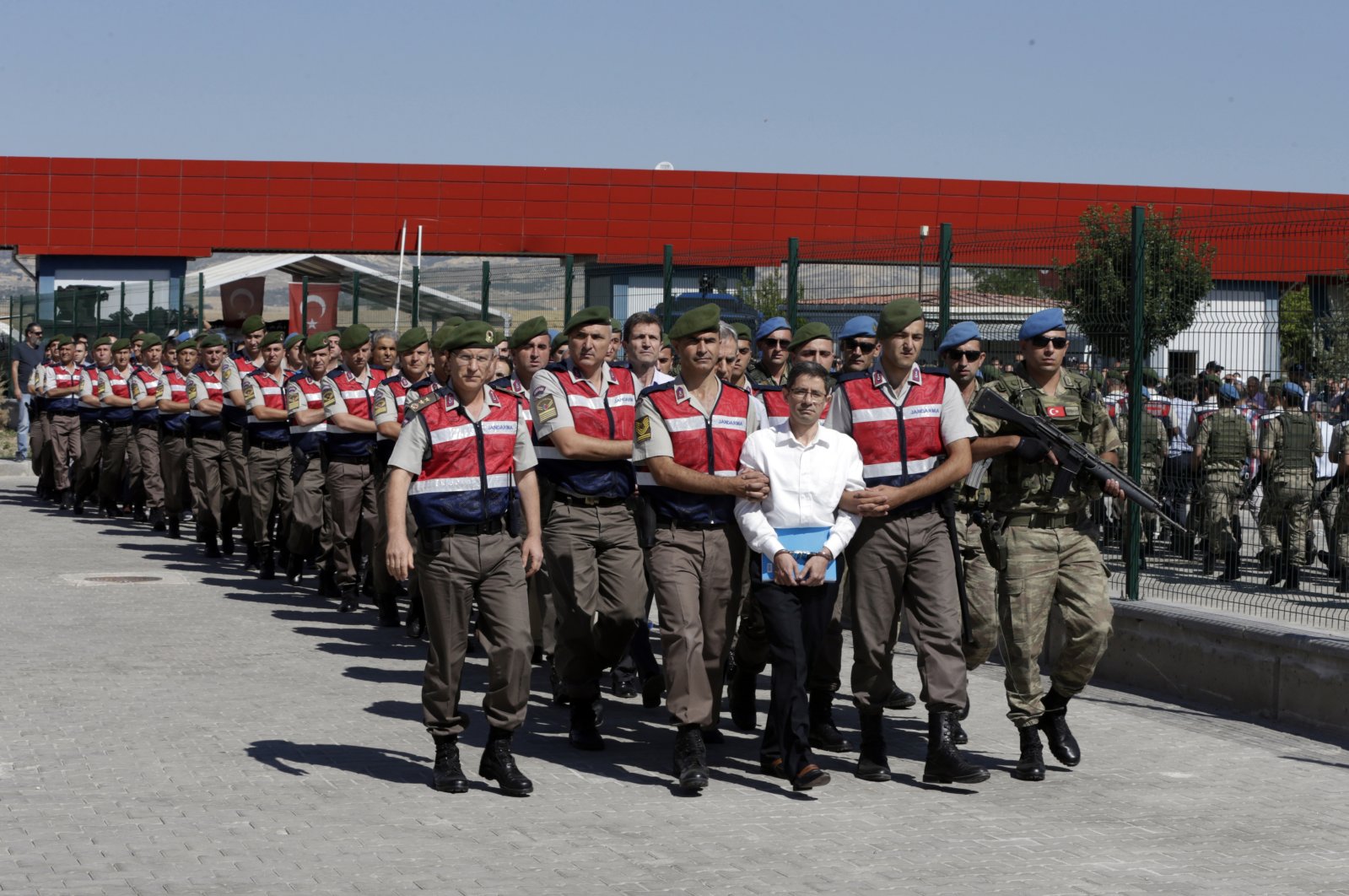 Officers escort suspects of FETÖ's coup attempt to the courthouse for a trial in the capital Ankara, Türkiye, Aug. 1, 2017. (AP Photo)