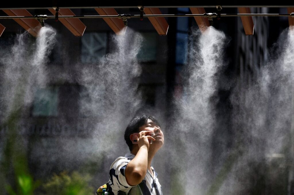 A man takes a break under a cooling mist in Tokyo, Japan July 9, 2024. (Reuters Photo)