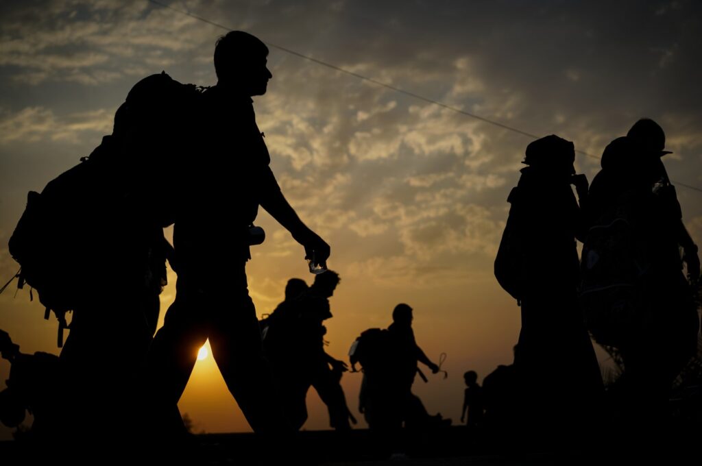 A silhouette of immigrants walking before sunset. (Getty Images Photo)