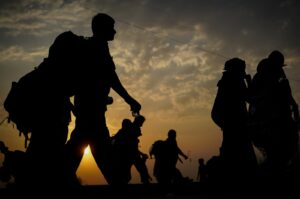 A silhouette of immigrants walking before sunset. (Getty Images Photo)
