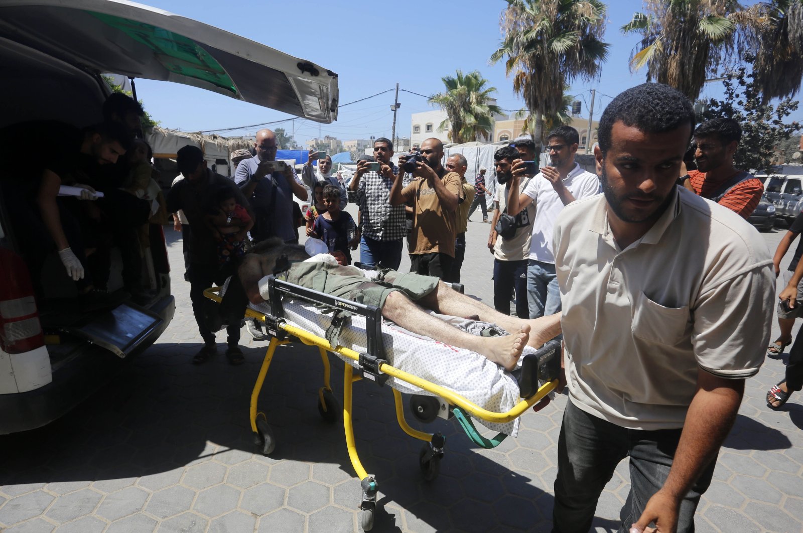 People carry the injured to a hospital after an Israeli attack on a refugee camp, Deir al-Balah, Gaza Strip, Palestine, July 9, 2024. (AA Photo)