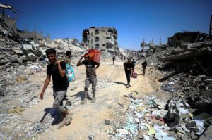 Palestinians make their way as they inspect the damage following an Israeli ground operation in the eastern part of Gaza City, Palestine, July 10, 2024. (Reuters Photo)