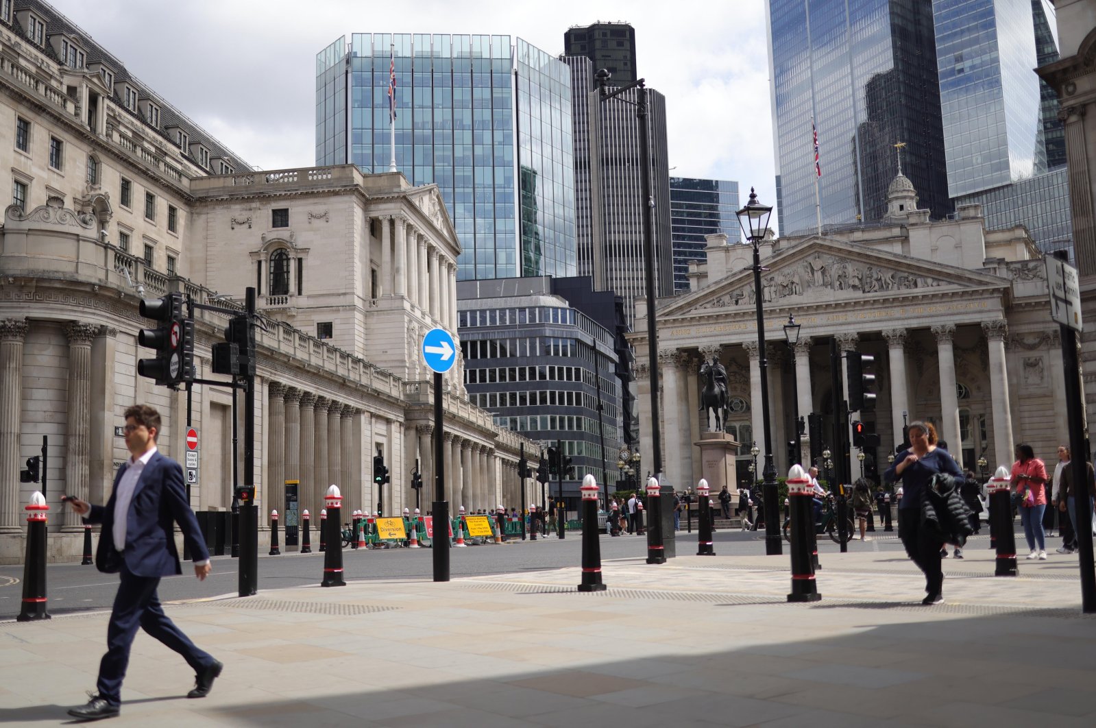 People walk past the Bank of England in the City of London financial district, London, U.K., June 19, 2024. (EPA Photo)